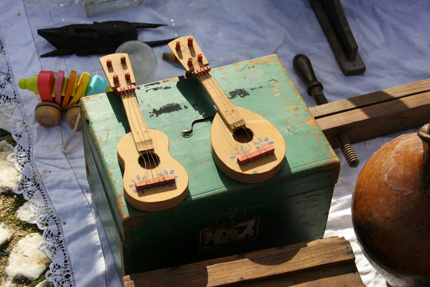 Two toy guitars on a vintage teal box.